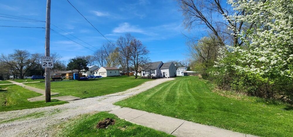 Mowed front lawn and driveway on a sunny day